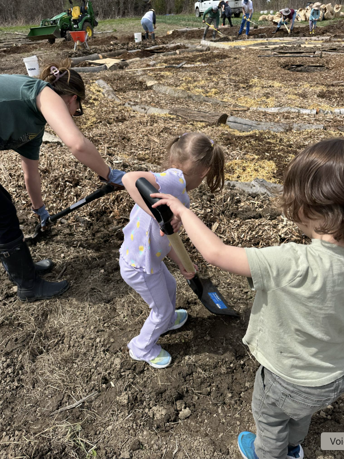 Kids participating and helping out digging in the garden