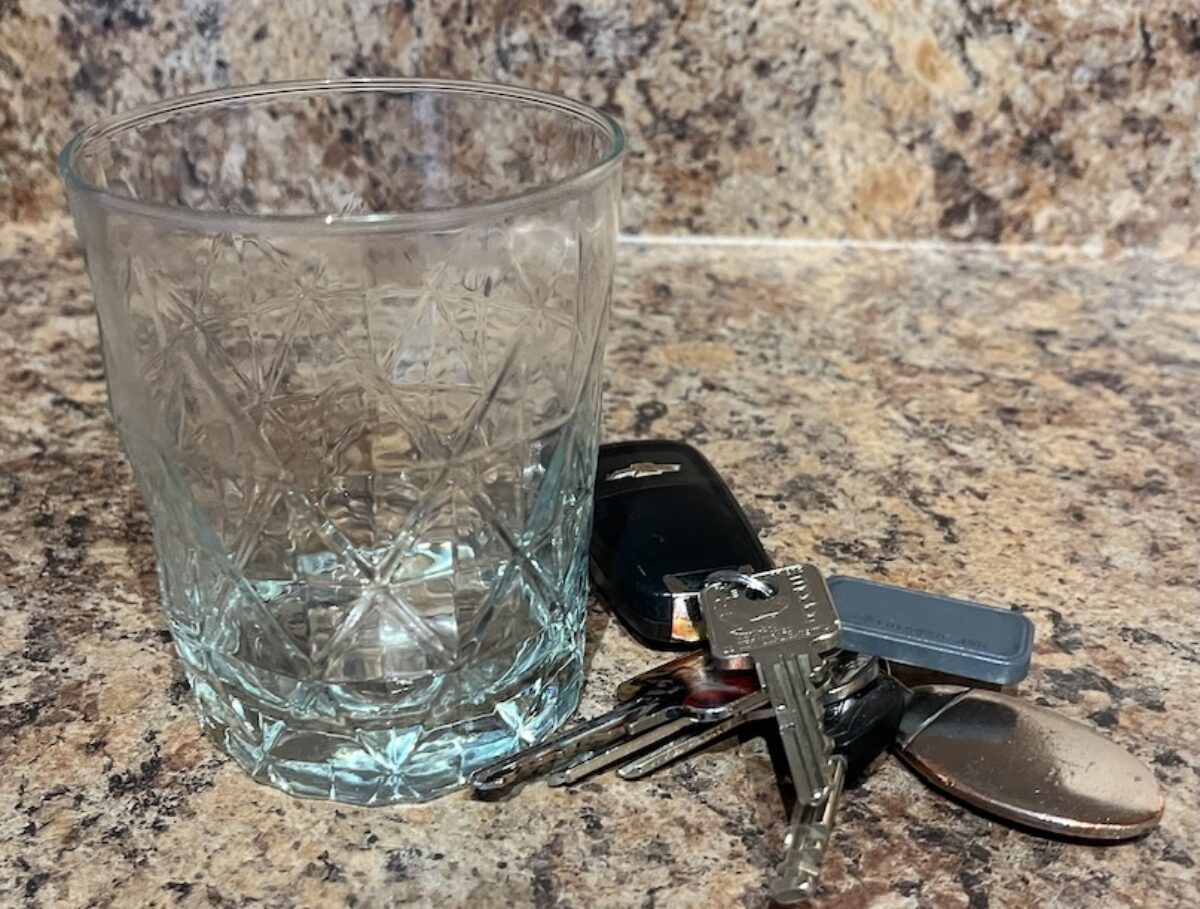 Photo of an empty glass and car keys
