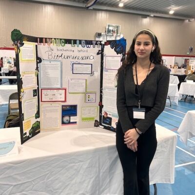 Kanien’kwentha McComber in front of her project