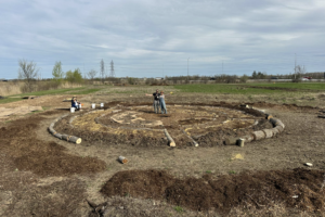Brooke Rice (right) with Dr. Andrew Judge (left) posing in the circular seed garden they have built togheter.