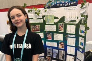 Kahnawiiostha Whyte-Turner in front of her project.