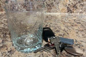 Photo of an empty glass and car keys