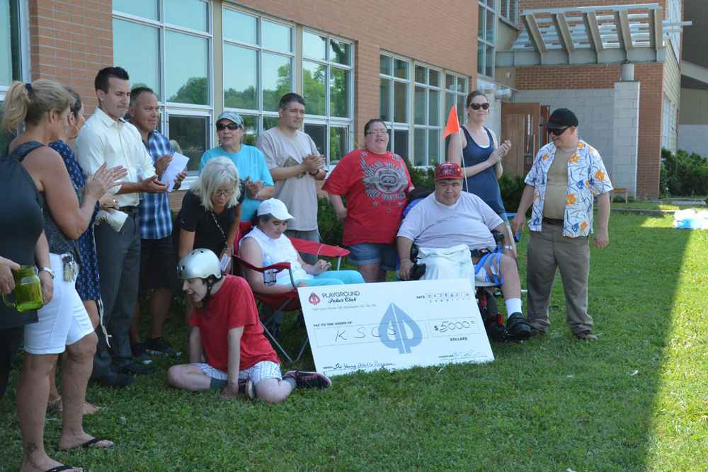Mackenzie Kirby and Bobby Delaronde of Playground Poker present YAP with the generous donation.