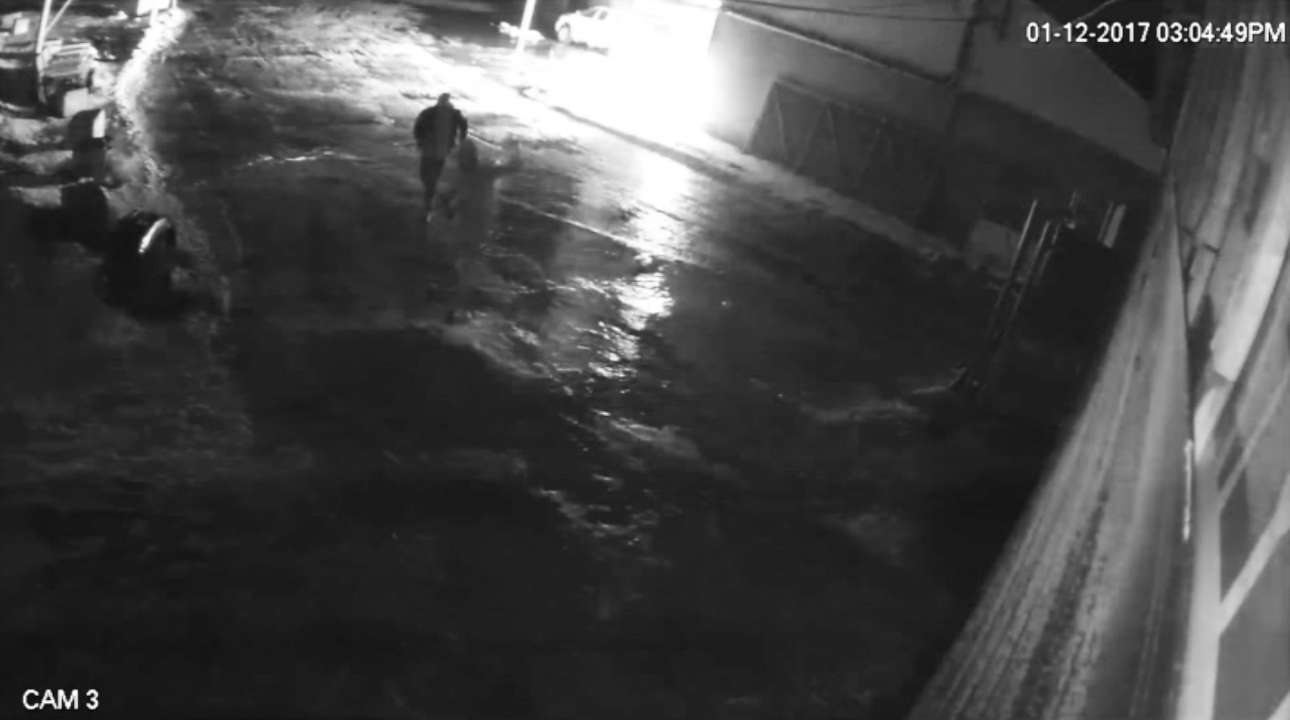 Two suspects carrying gas cans and bags were observed walking towards the back of the HR Kustom Motorcycles unit and within minutes large flames were observed.